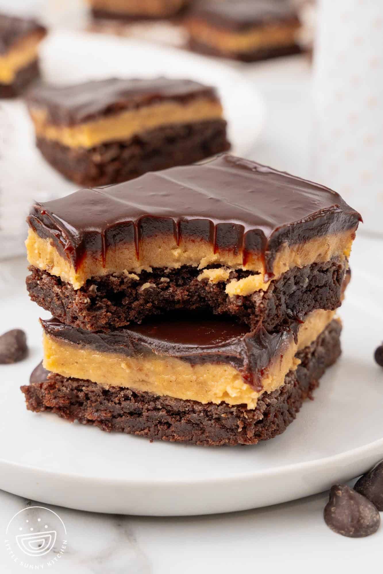 Two stacked buckeye brownies. The top has a bite taken from it.