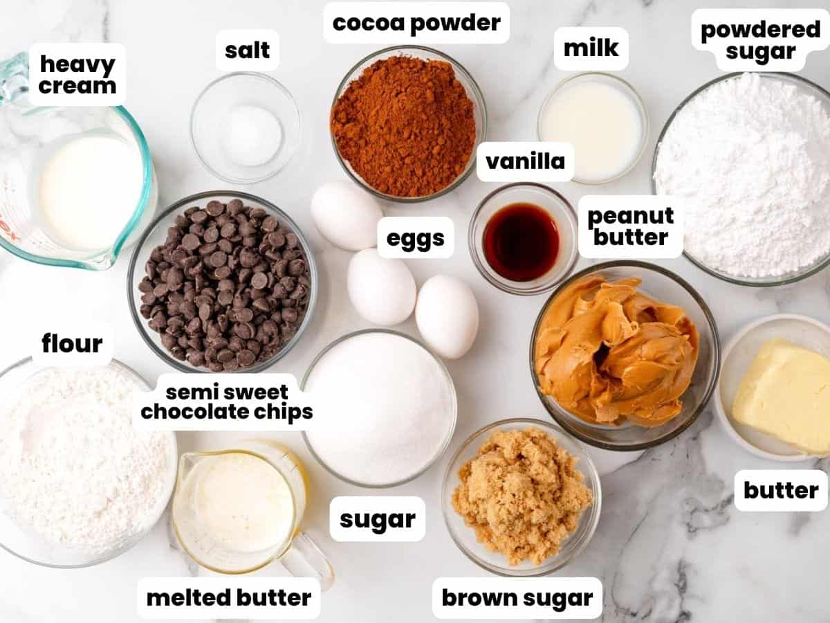 The ingredients needed to bake a recipe for Buckeye Brownies, all measured into glass bowls and arranged on a counter.