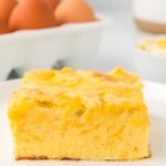 a square piece of crustless egg casserole with green chiles and cheese.