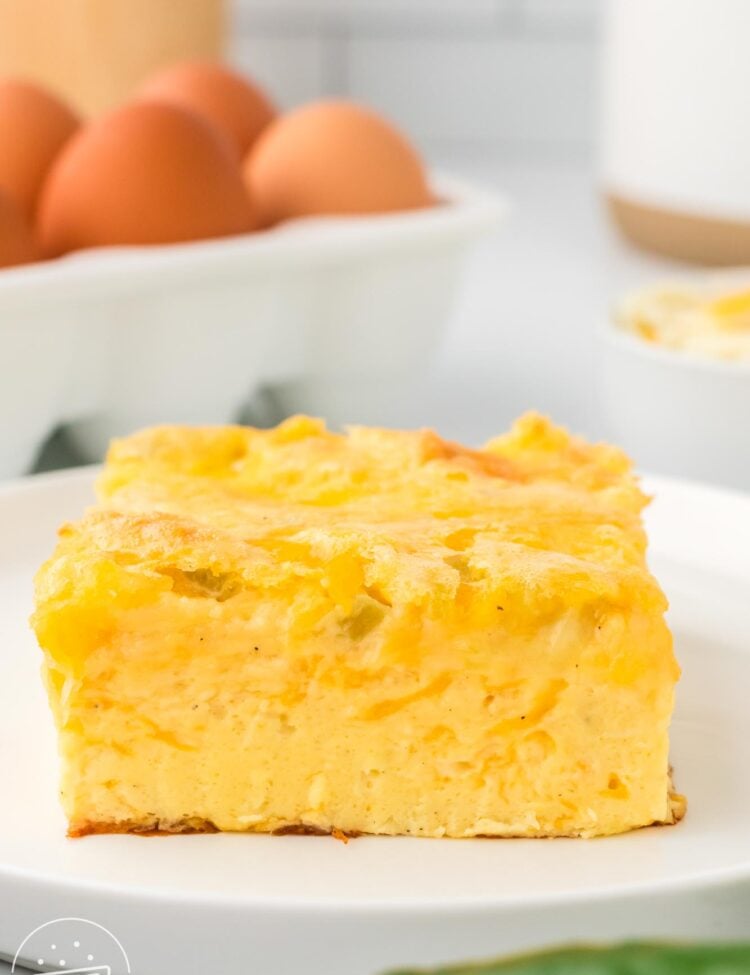 a square piece of crustless egg casserole with green chiles and cheese.