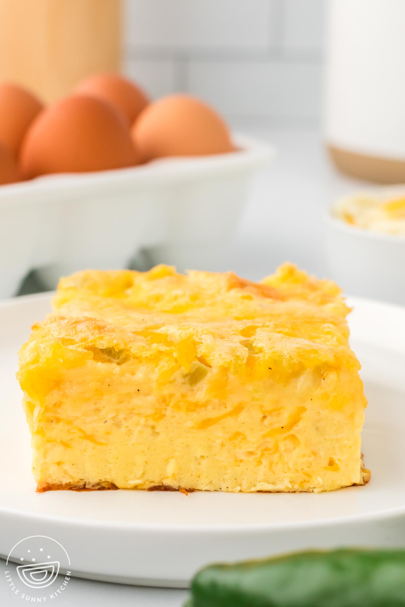 a square piece of crustless egg casserole with green chiles and cheese.