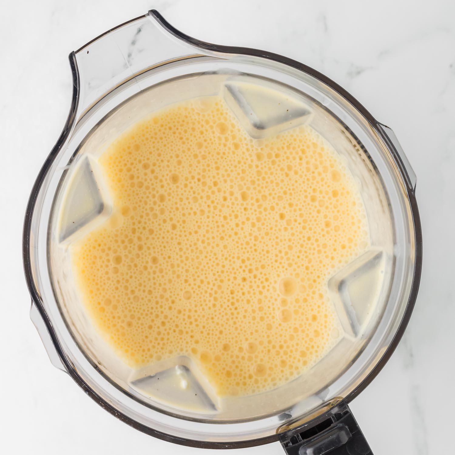 blended egg casserole mixture in a blender pitcher, viewed from overhead.