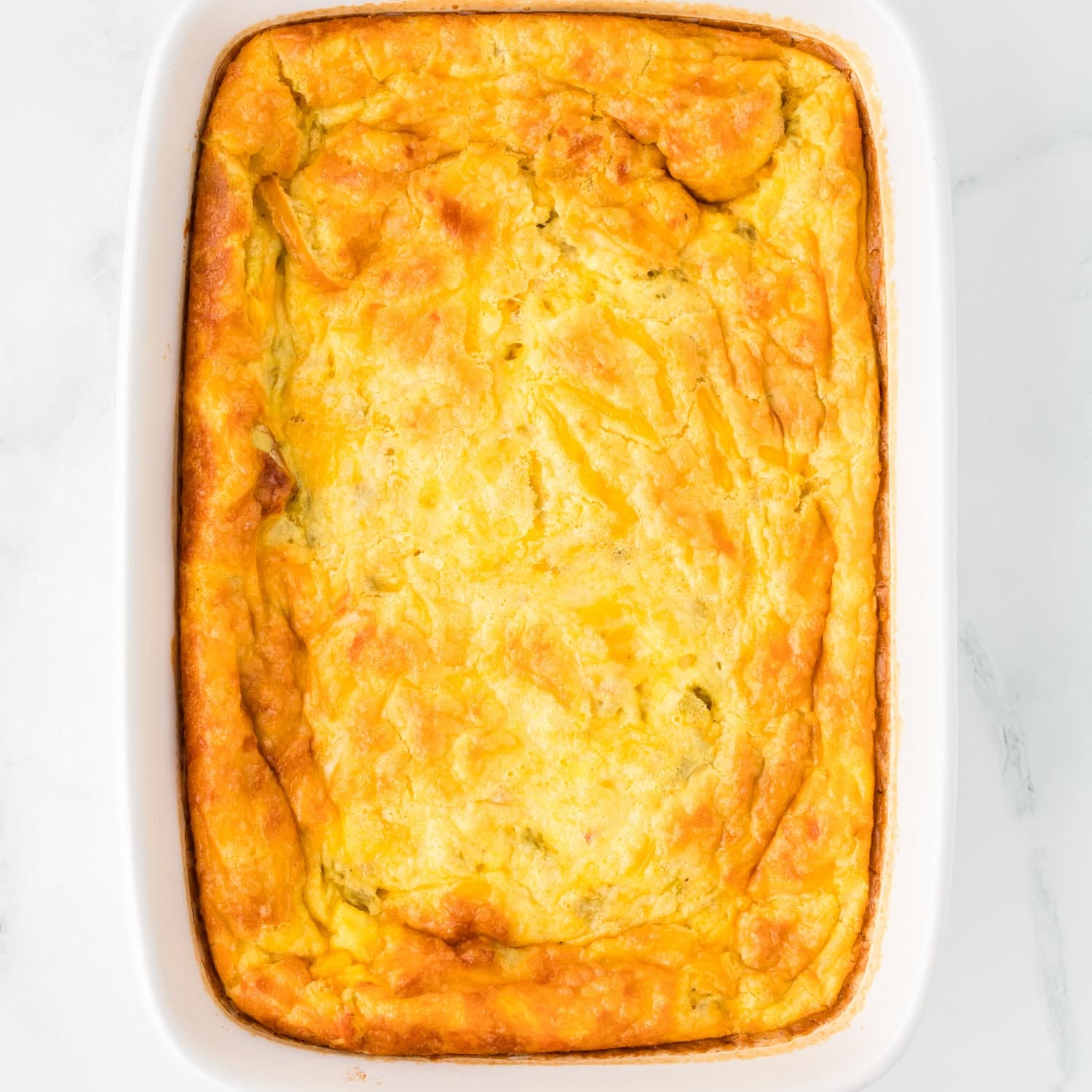 baked green chili egg casserole in a 9x13 inch pan with golden brown edges.