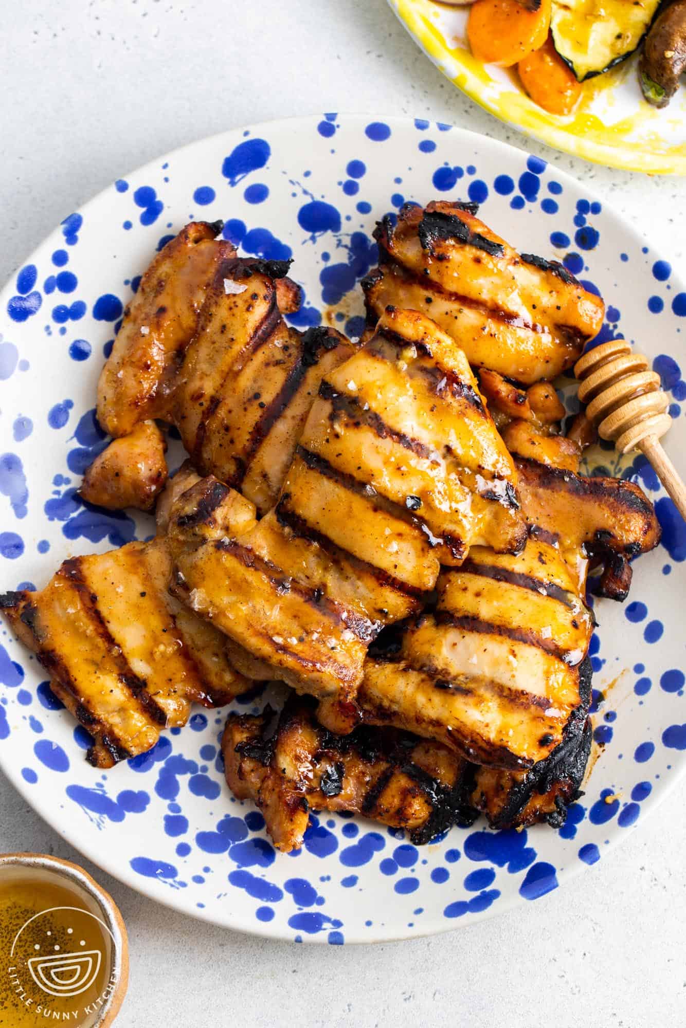 a blue and white spotted plate of honey mustard marinated chicken.