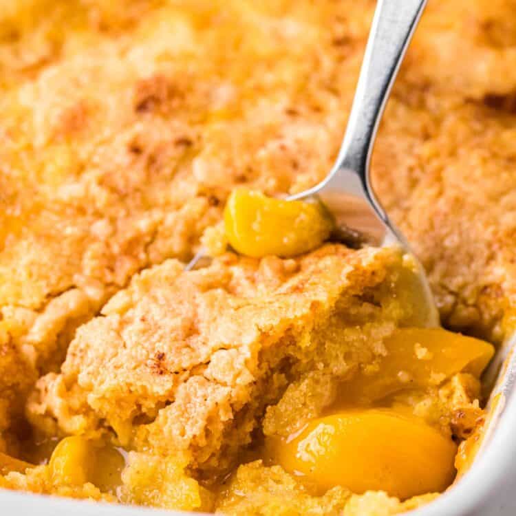 a spoon serving peach dump cake.