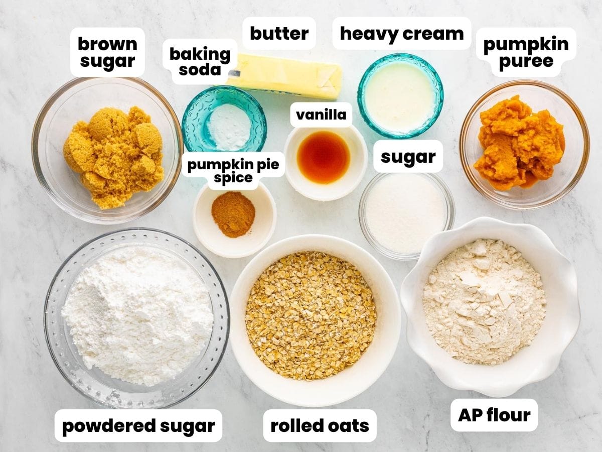 The ingredients needed to make pumpkin oatmeal cookies, all measured into small bowls and arranged on a counter.