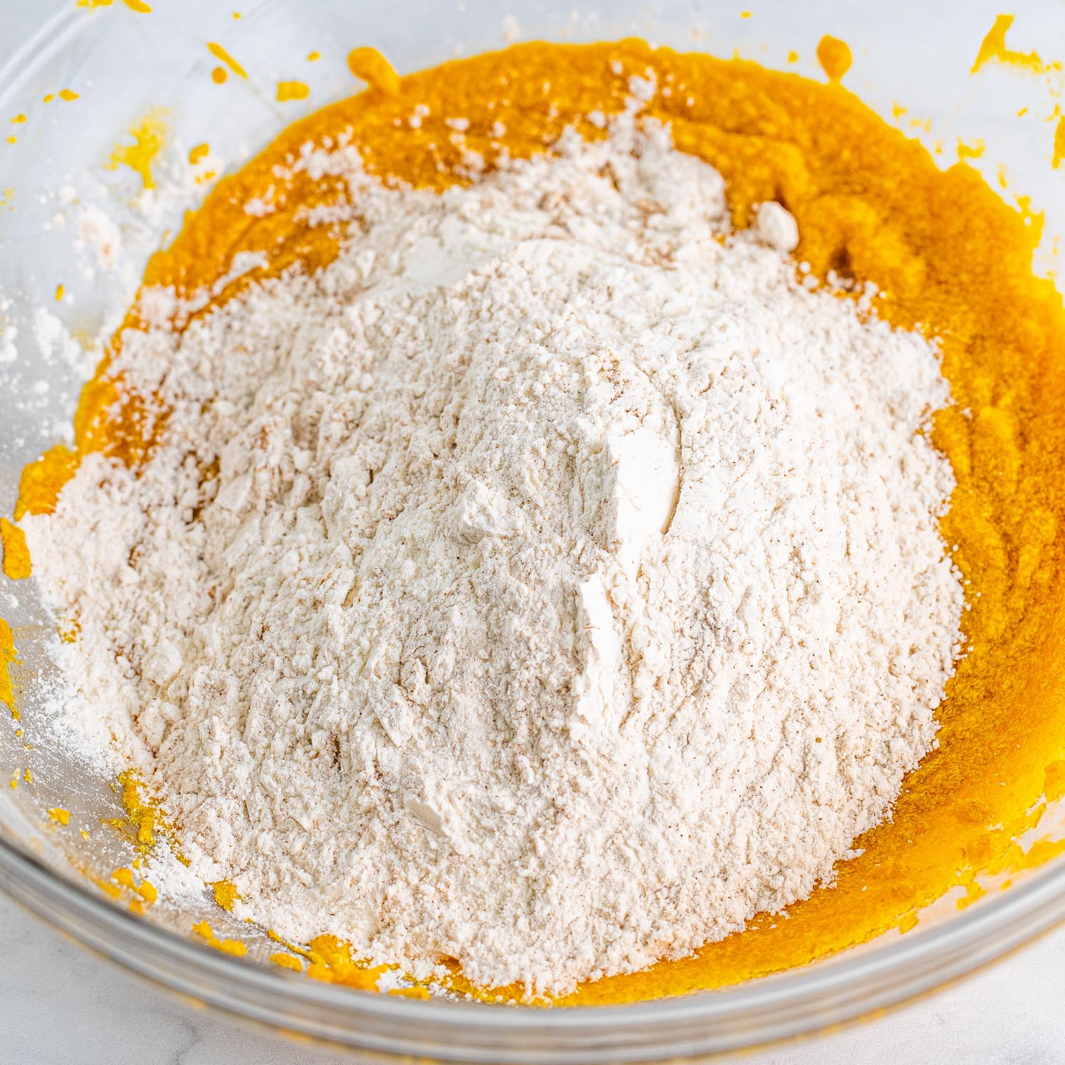 dry ingredients added to pumpkin puree to make cookies.