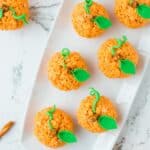 A rectangular platter holding pumpkin shaped rice krispie treats.