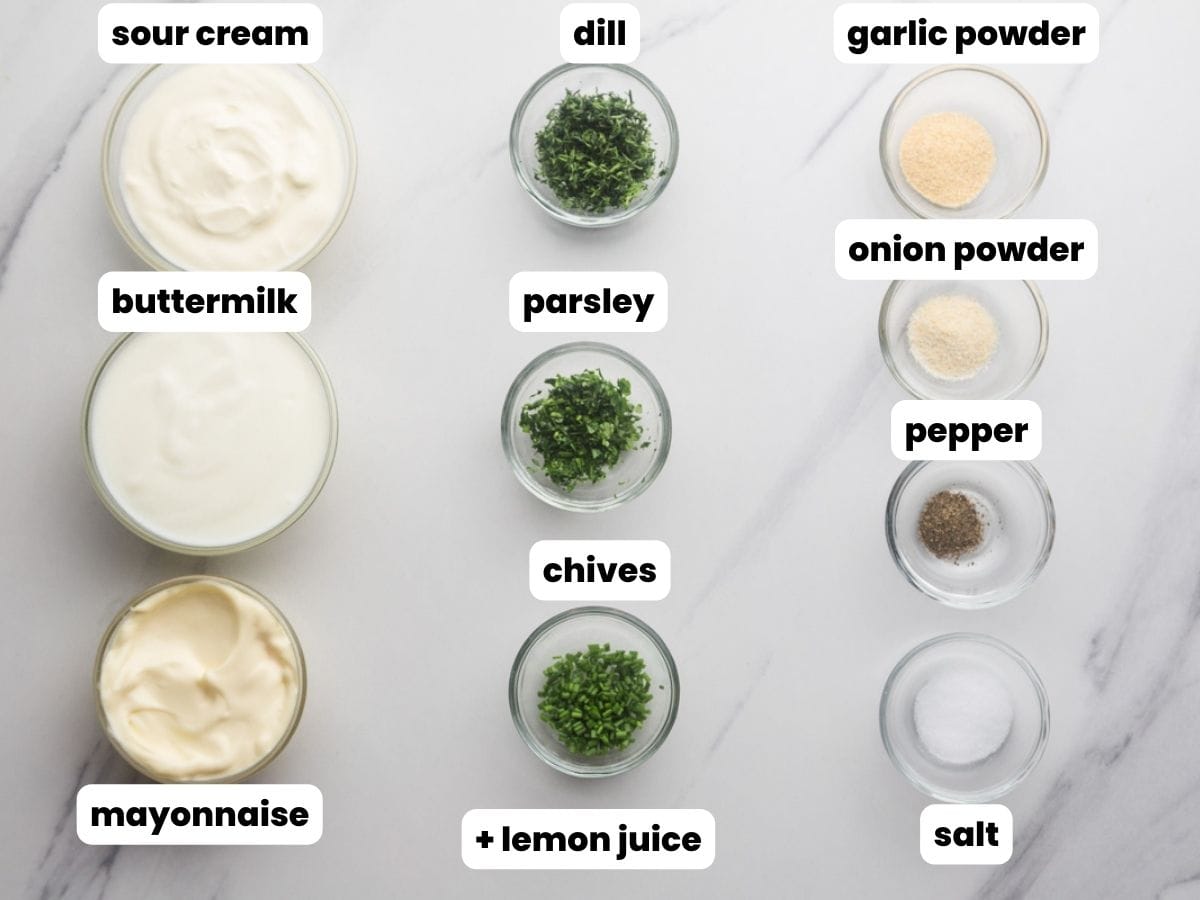 Ingredients needed to make a ranch dressing including buttermilk, sour cream, mayo, herbs, and spices.
