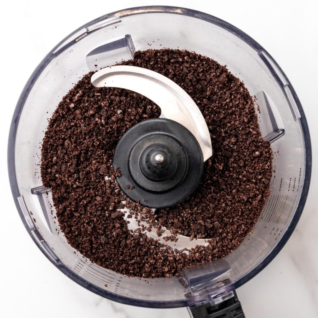 Oreo cookies chopped in a food processor bowl.