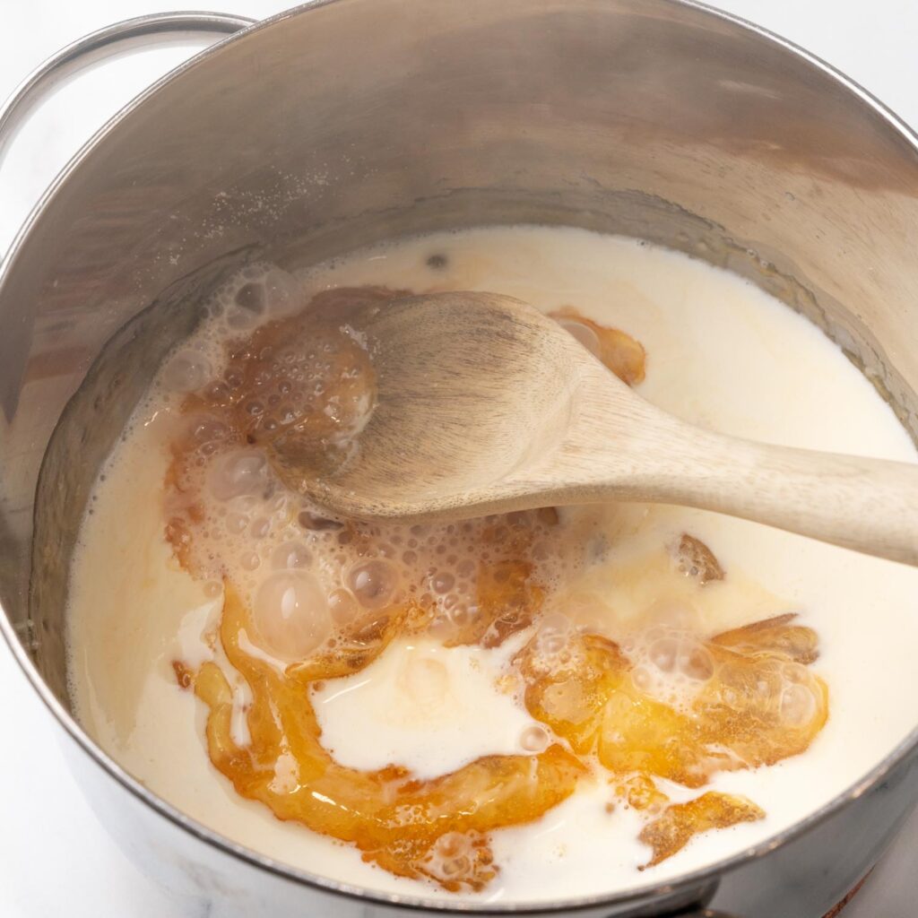 sugar and cream cooking in a saucepan.