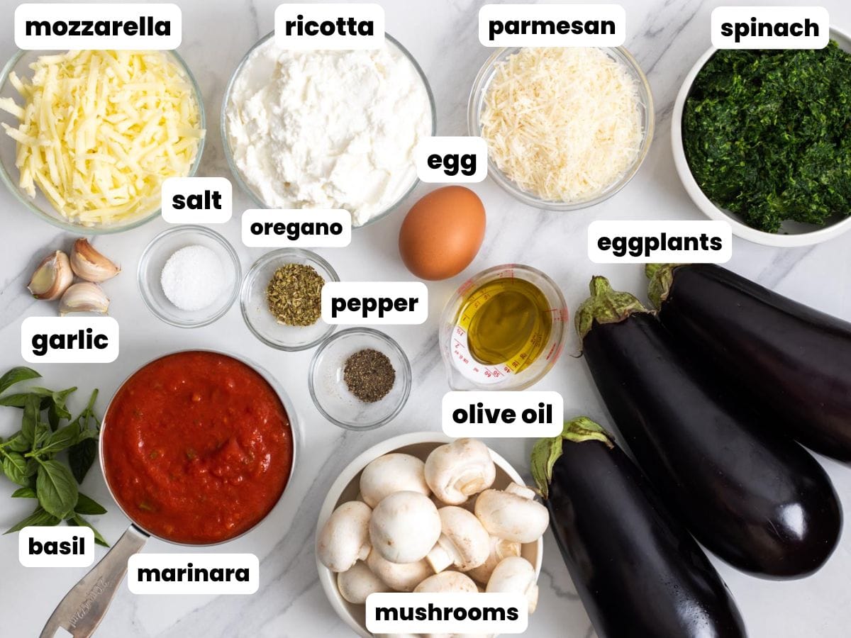 The ingredients for vegetarian eggplant lasagna, arranged on a counter in separate bowls.