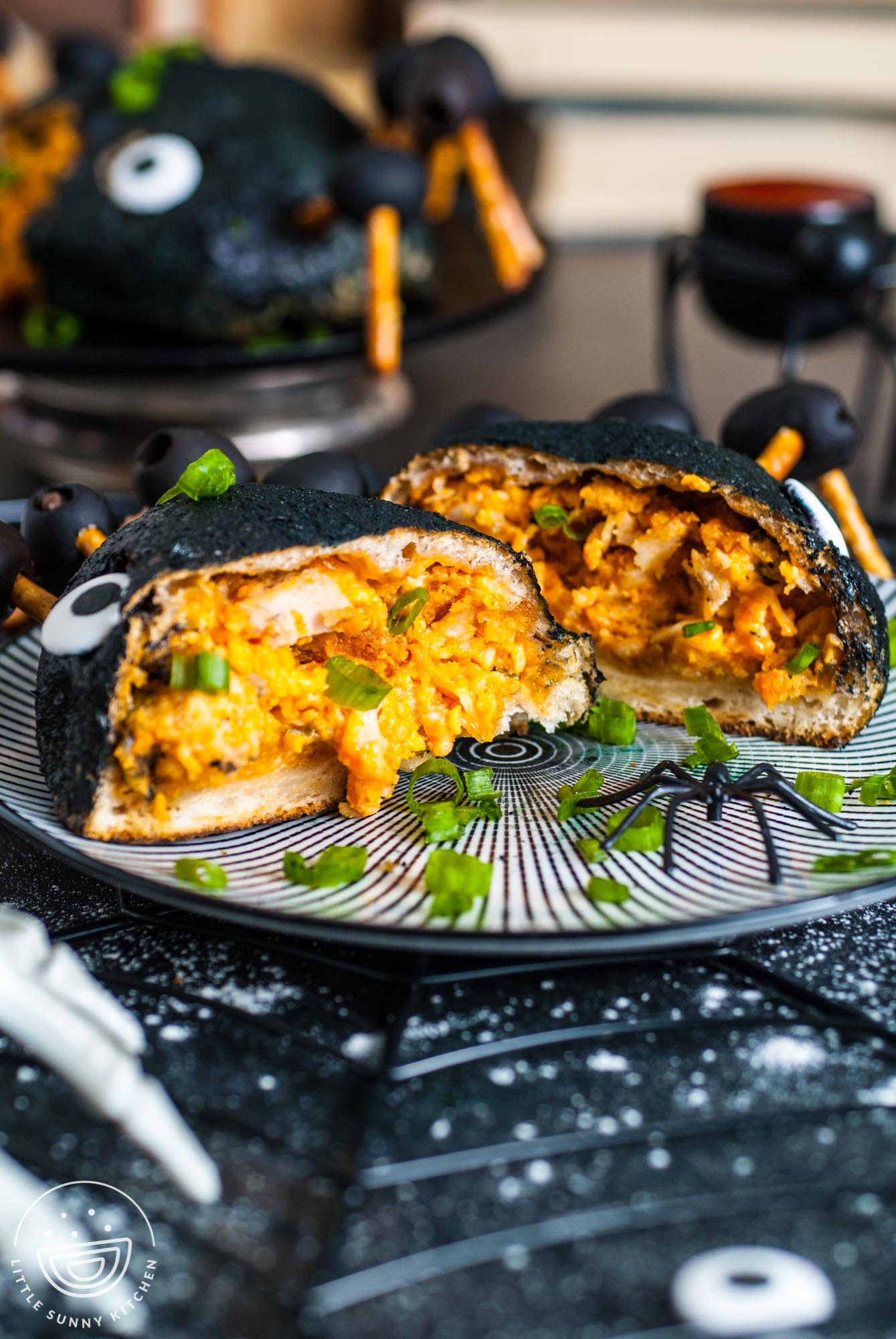 a halloween buffalo chicken bomb cut in half to show the chicken and cheese filling.