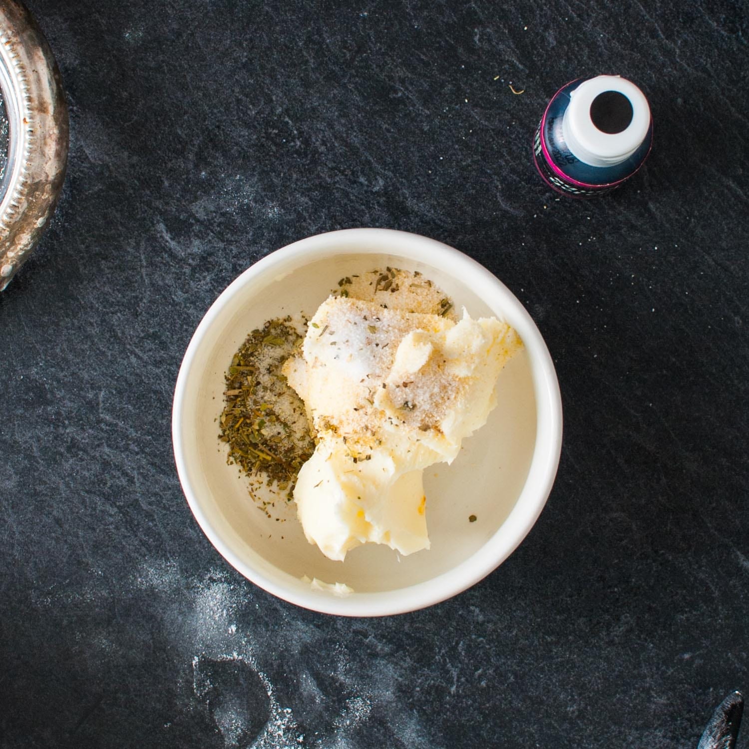 a small white ramekin filled with butter and herbs.