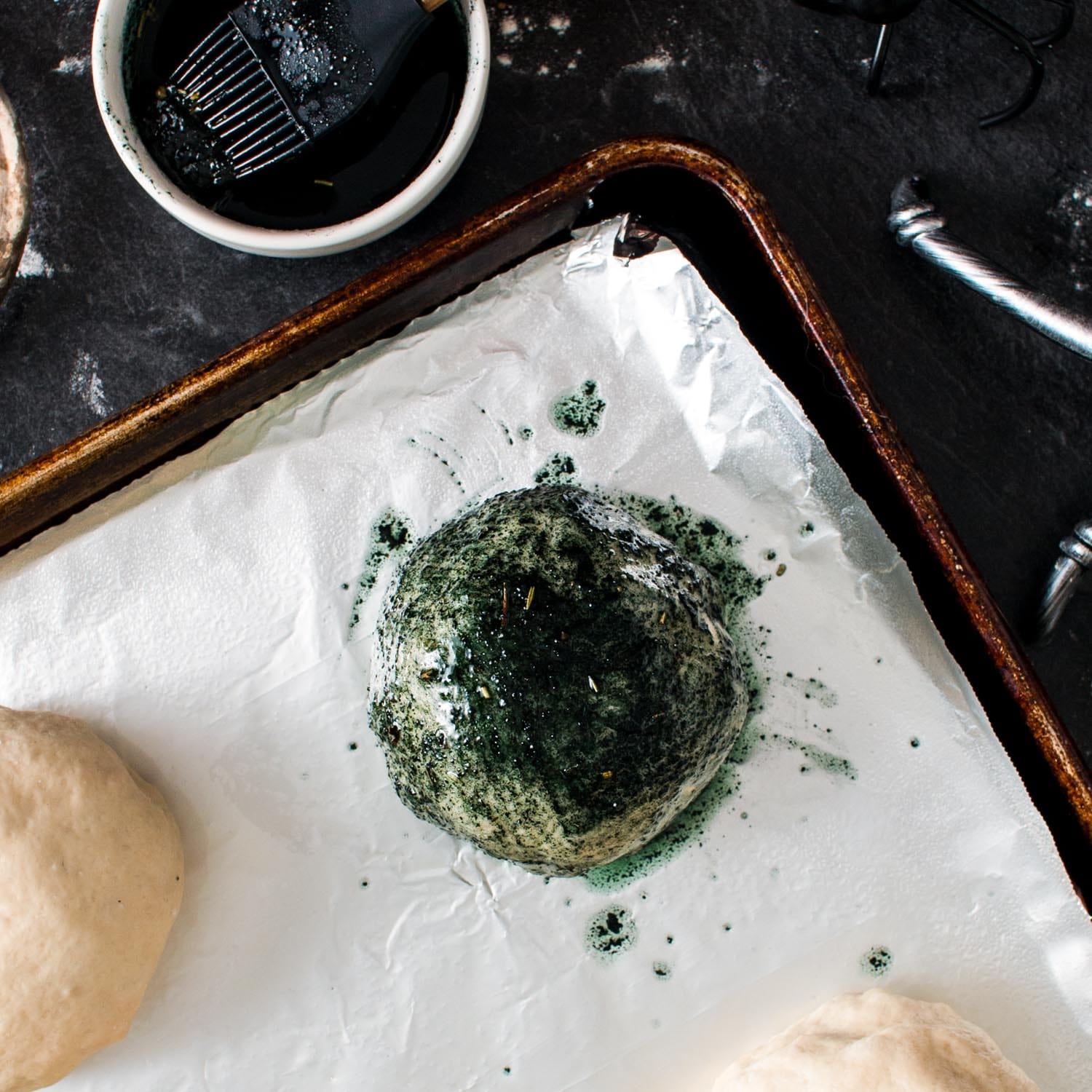 buffalo chicken balls wrapped in pizza dough, covered with black garlic butter.