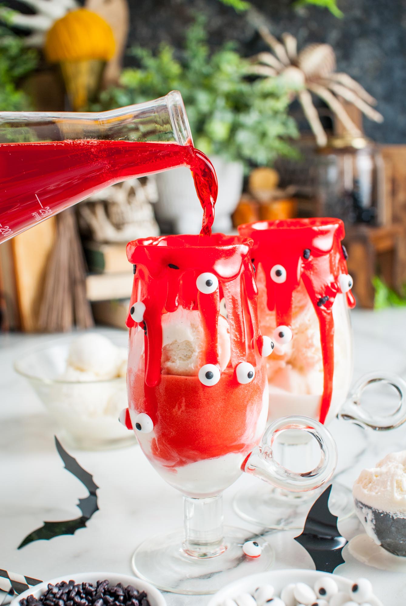 bloody red fruit punch soda poured into glasses of ice cream to create halloween vampire floats.