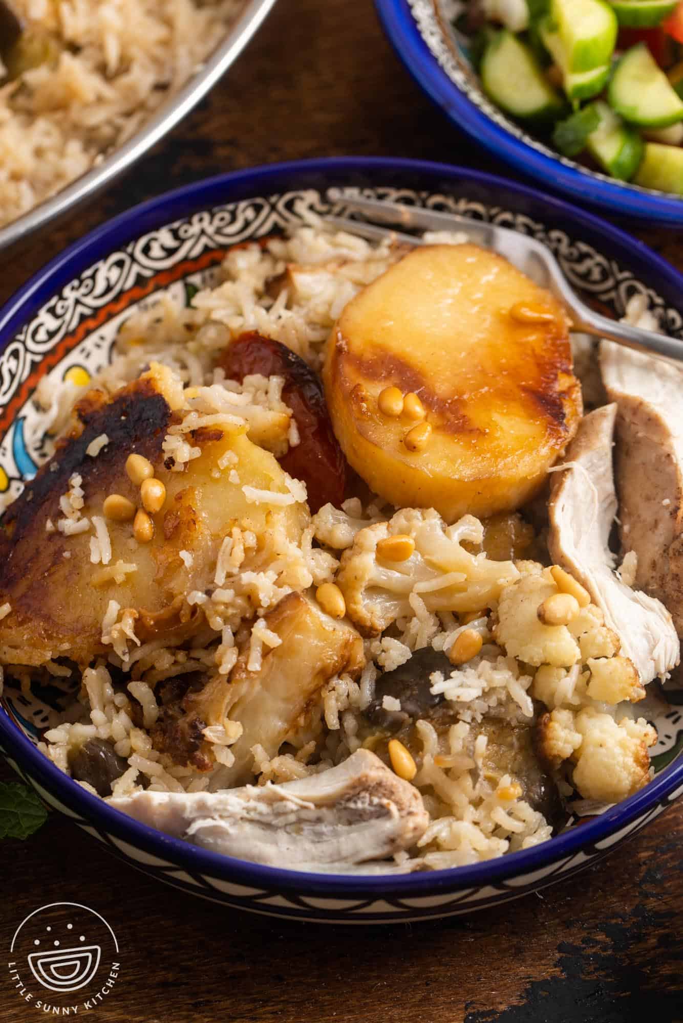 Chicken maqluba plated in a traditional palestinian bowl