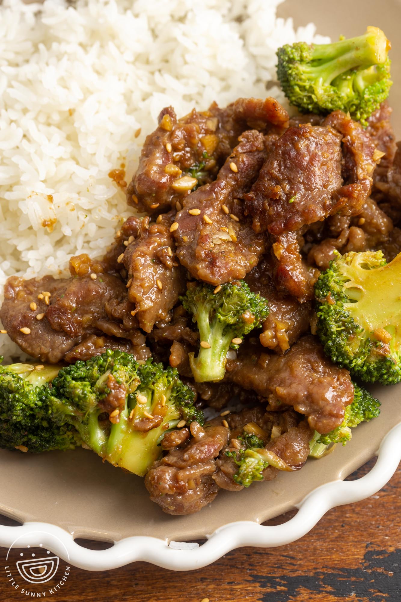 beef and broccoli stir fry on a plate with white rice.