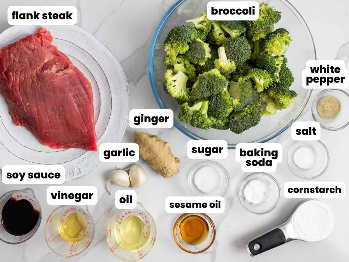 The ingredients needed to make homemade chinese beef and broccoli including flank steak, garlic, and ginger.