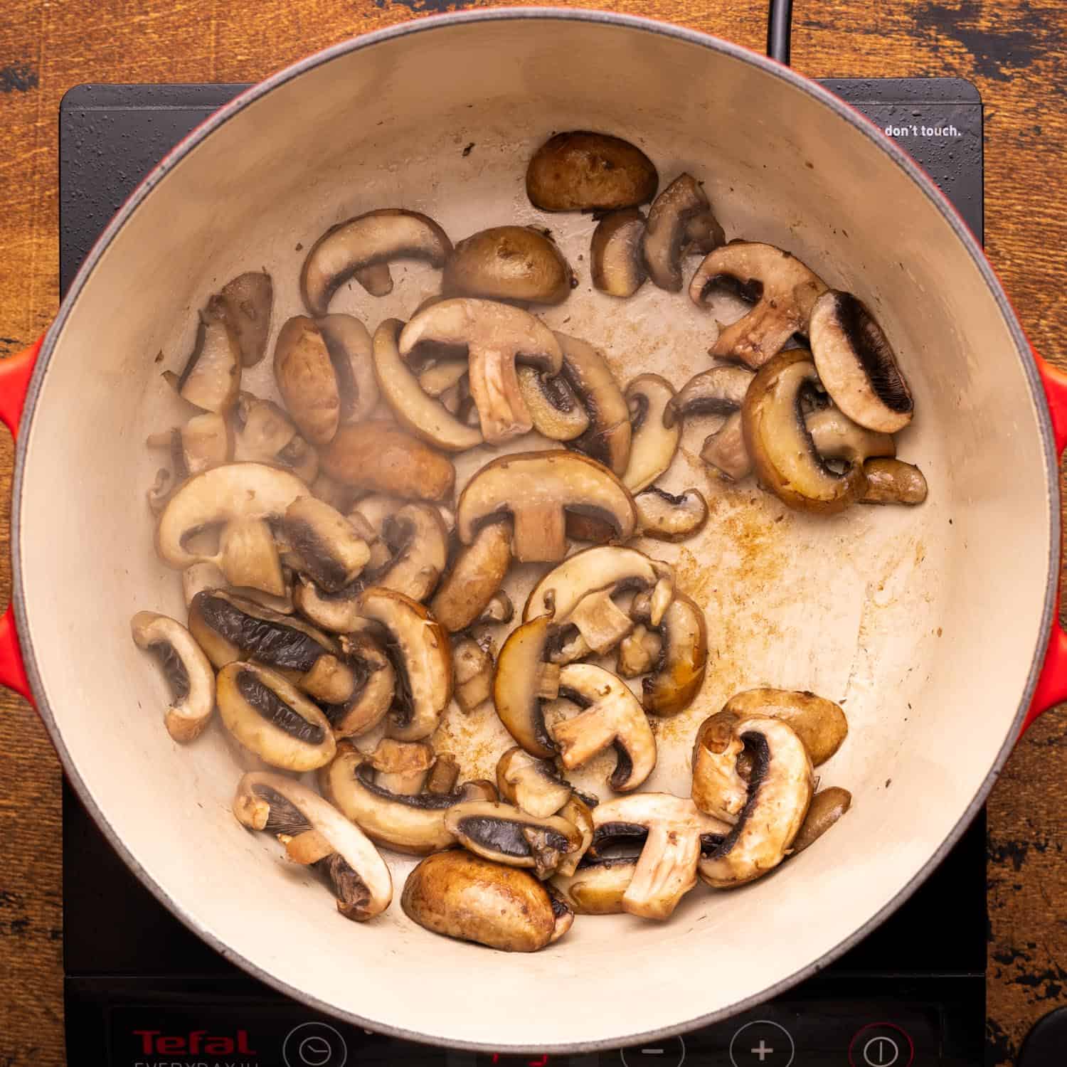 sauteed sliced mushrooms in a dutch oven.