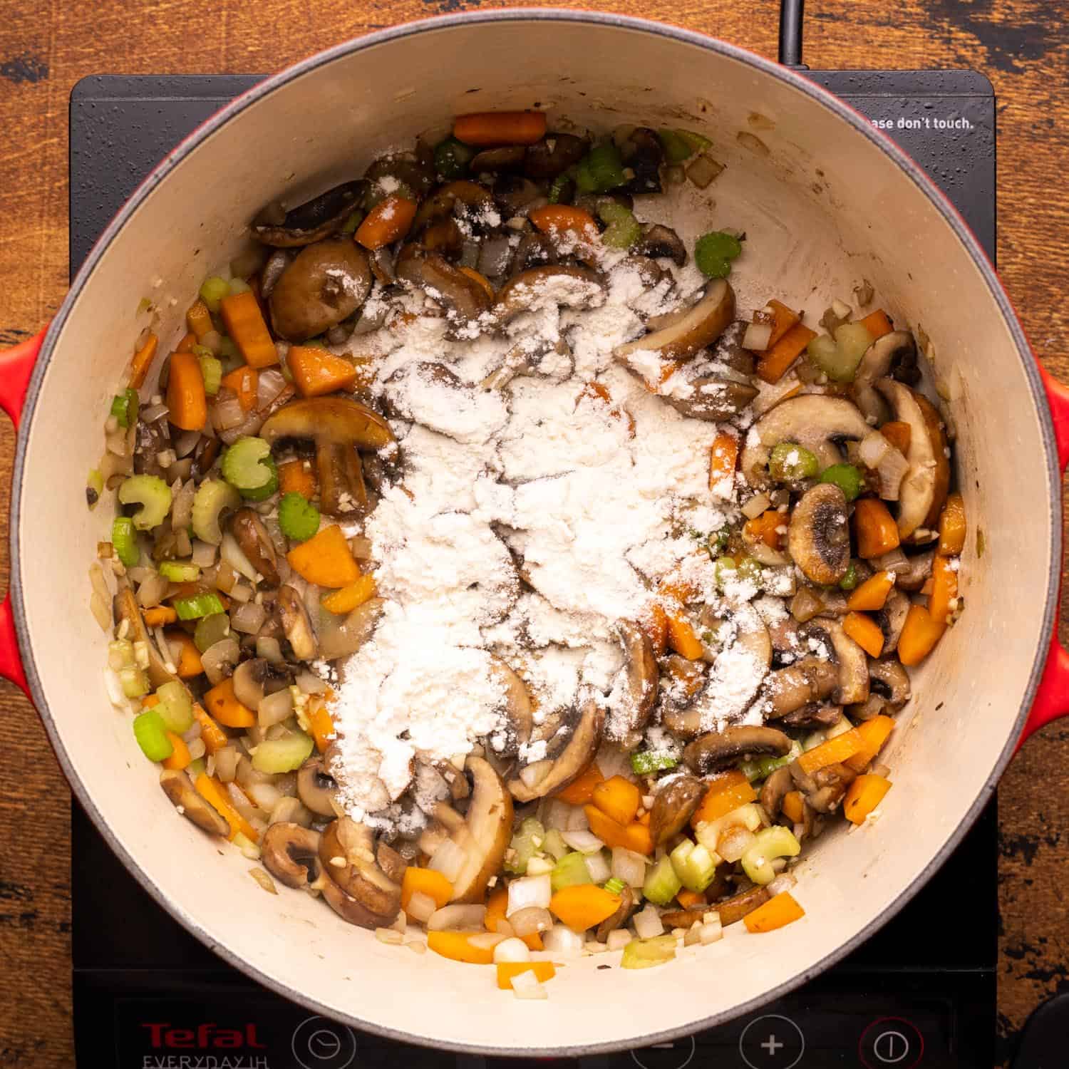 flour added to a pot of sauteed soup veggies.