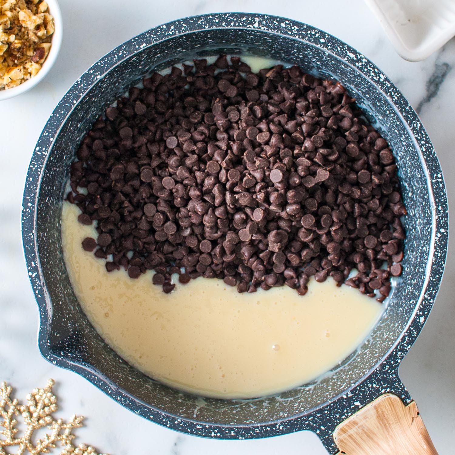 chocolate chips added to a pot with sweetened condensed milk to make fantasy fudge.