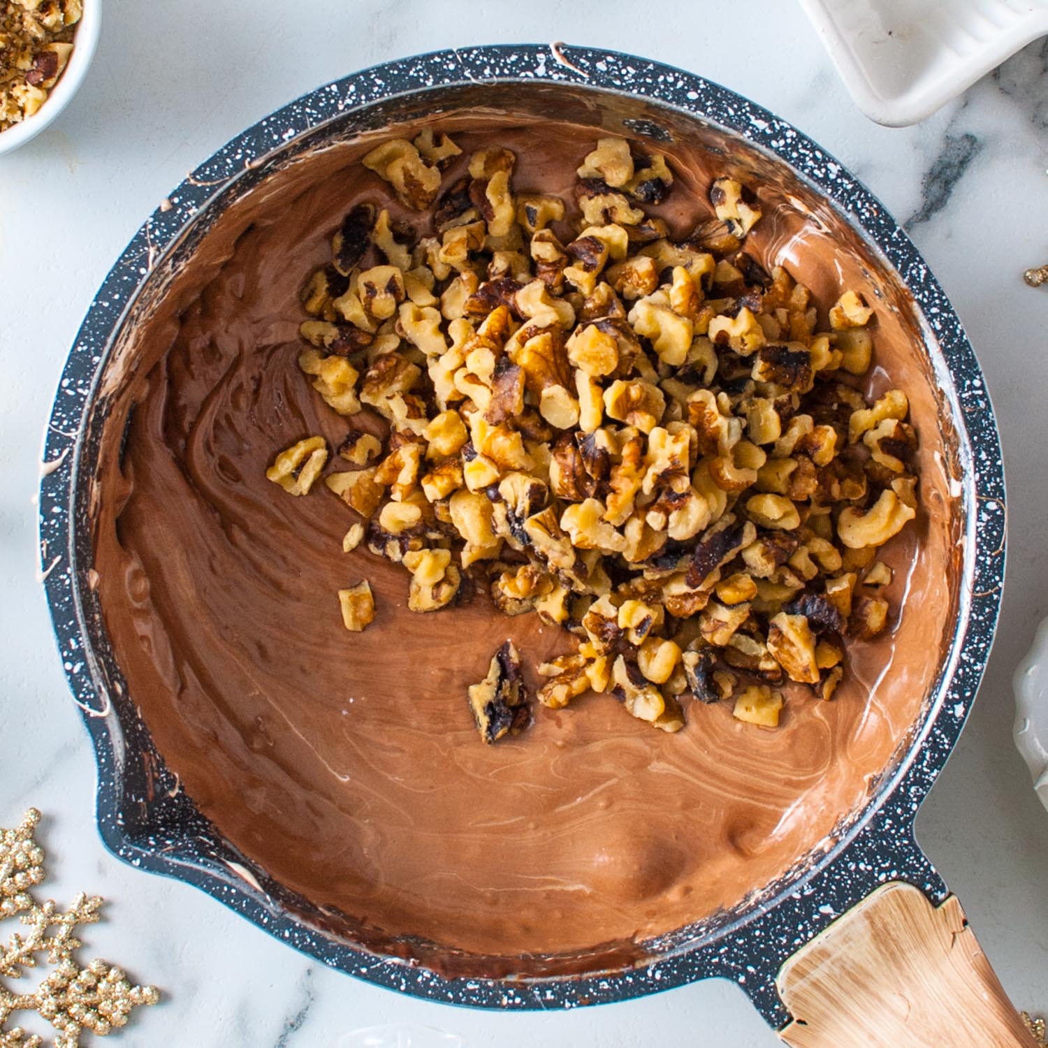 chopped walnuts added to a pot of fantasy fudge made with marshmallow creme.