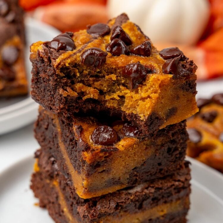 a stack of three brownies with pumpkin swirl and chocolate chips.