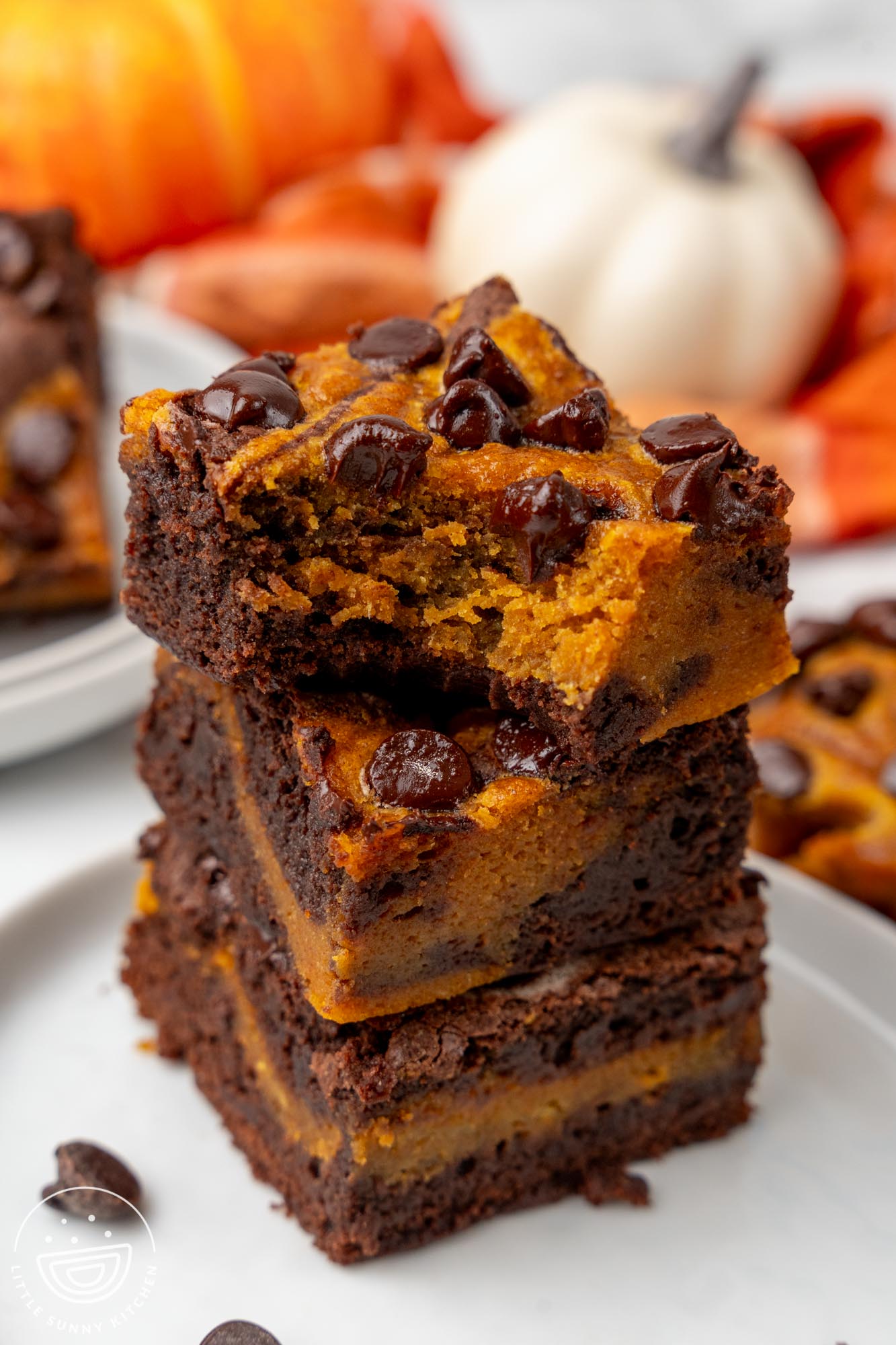 a stack of three brownies with pumpkin swirl and chocolate chips.