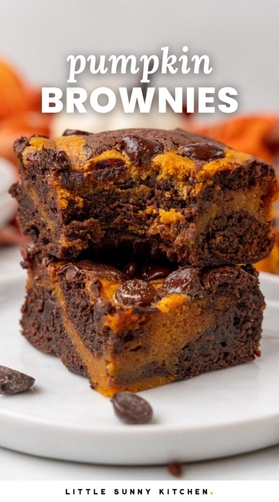 two pumpkin swirled brownies stacked on top of each other. Text overlay says "pumpkin brownies"