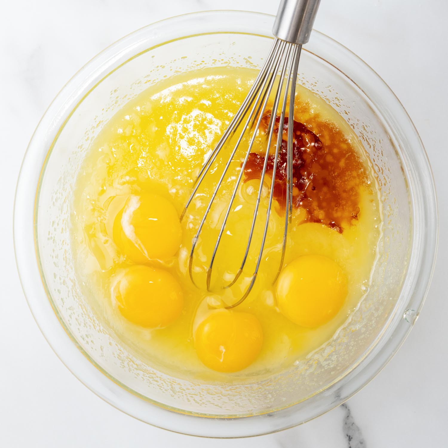 four eggs whisked with melted butter, sugar, and vanilla.