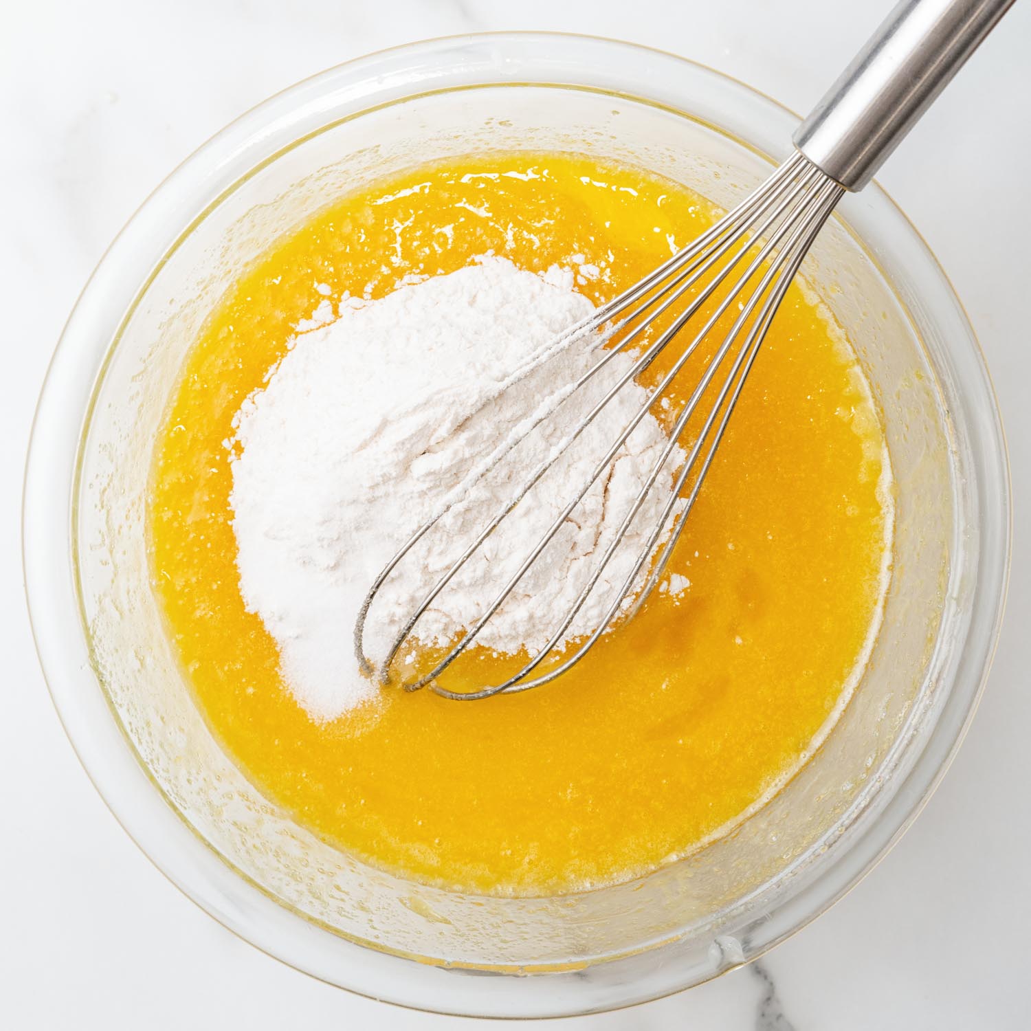 flour whisked into a bowl of melted butter, sugar, and eggs.