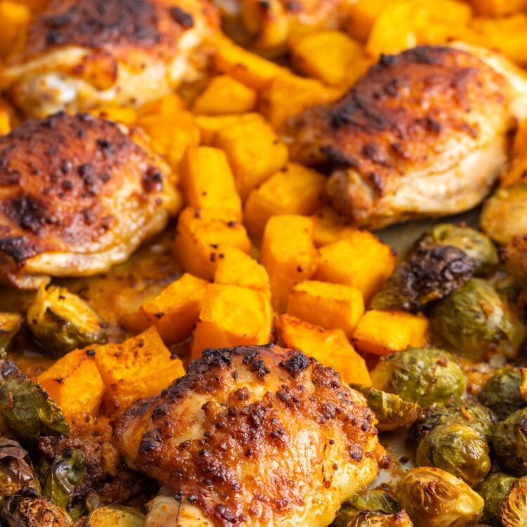 honey mustard chicken and fall veggies baked on a sheet pan.