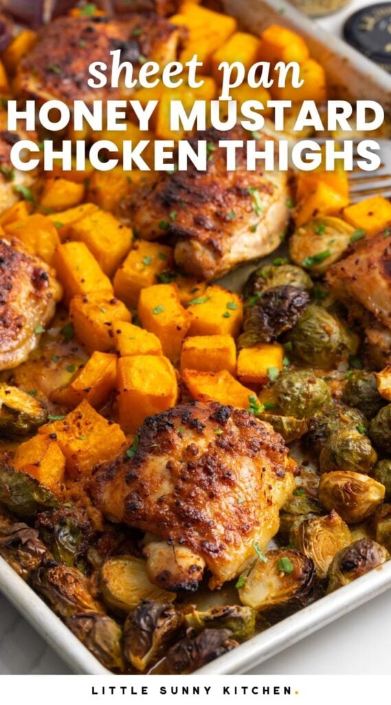 Chicken thighs with squash and brussels sprouts on a metal pan. Text overlay says "sheet pan honey mustard chicken thighs"