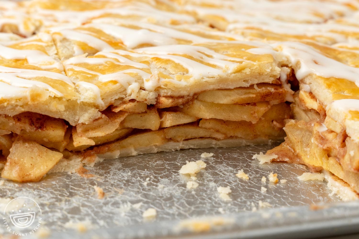 closeup of the inside of apple slab pie, showing layers of cooked apples.