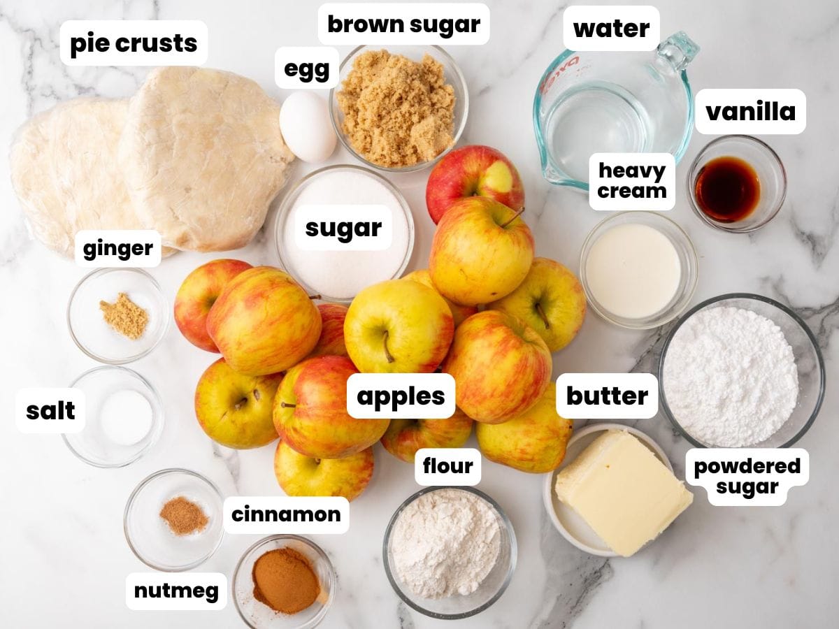 The ingredients needed to make apple slab pie, surrounding a pile of fresh apples.