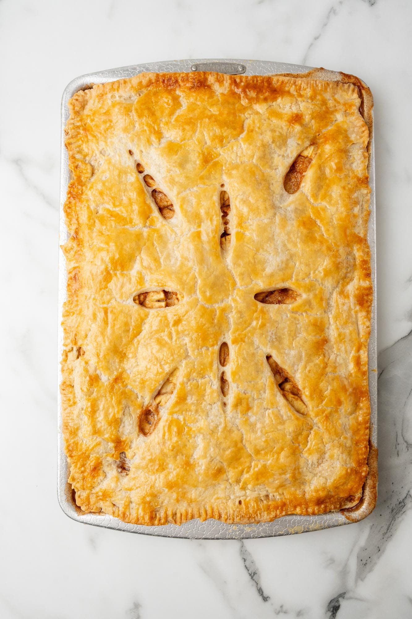 baked apple slab pie in a baking sheet.