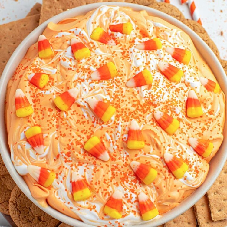 Overhead shot of candy corn dip served in a large white bowl