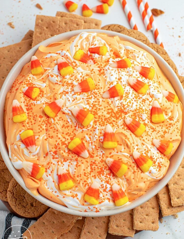 Overhead shot of candy corn dip served in a large white bowl