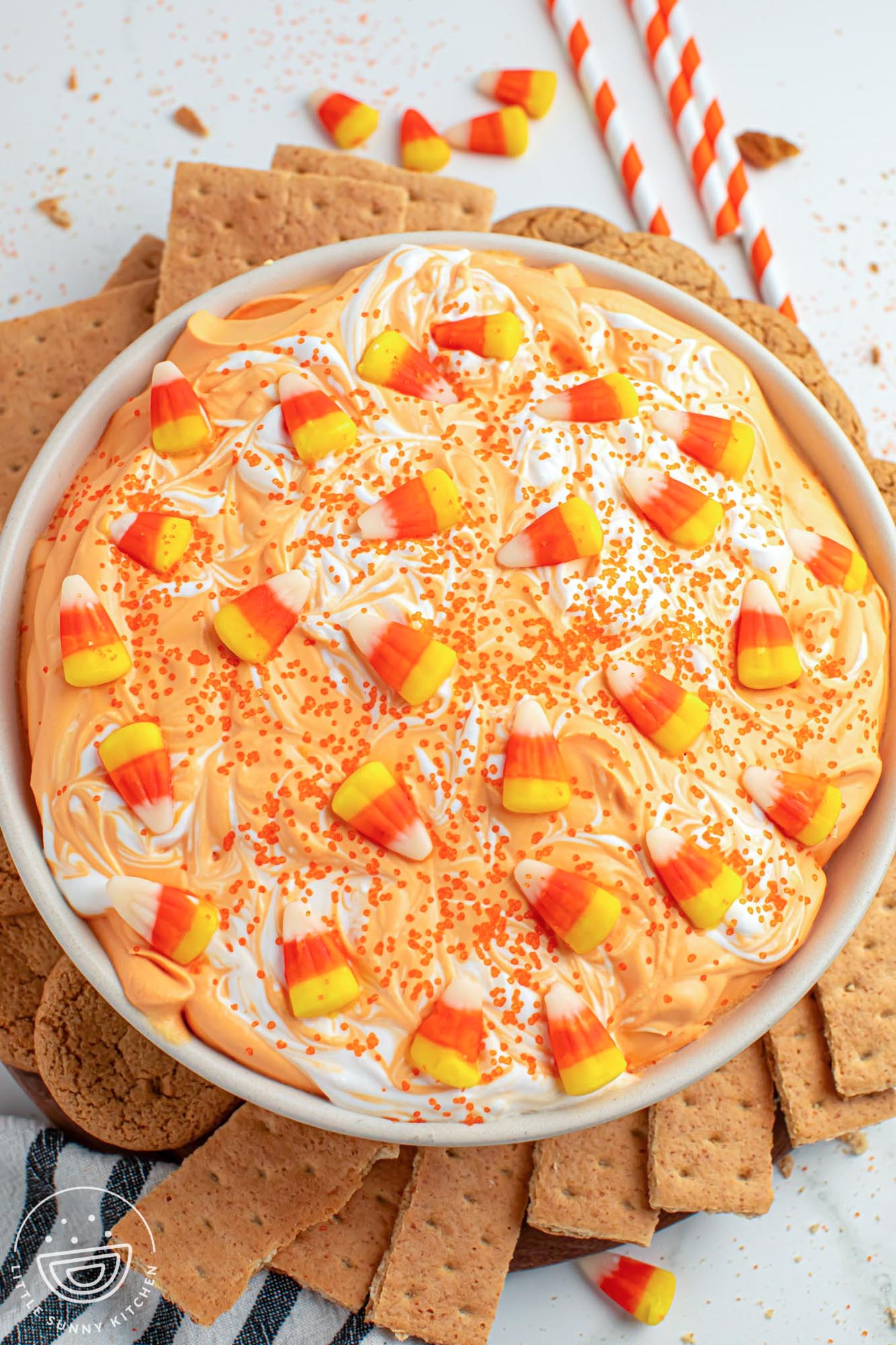 Overhead shot of candy corn dip served in a large white bowl