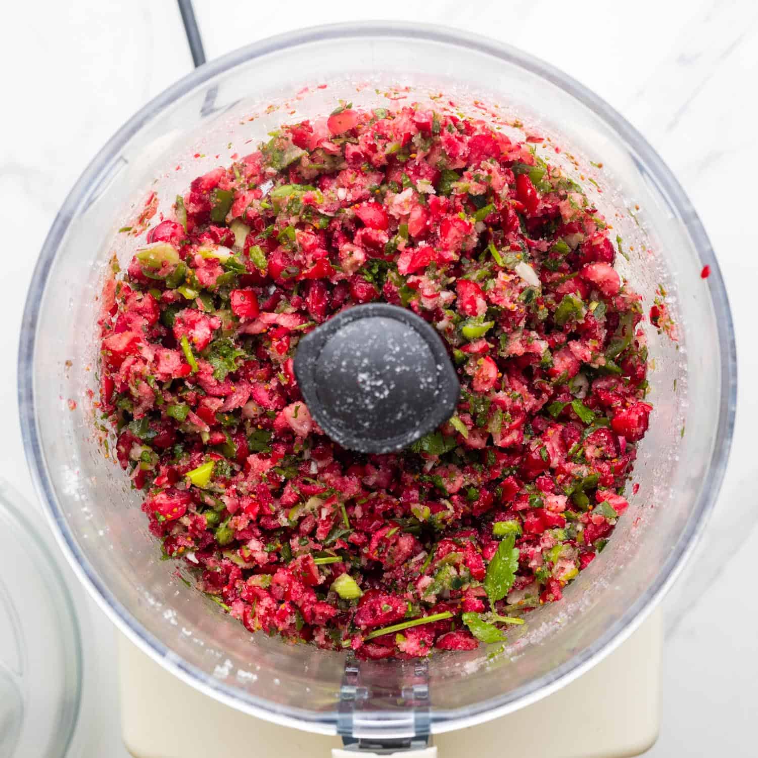 chopped cranberry salsa in the bowl of a food processor.