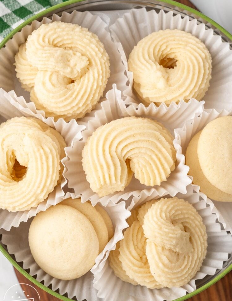 a tin of cookies wrapped in white paper liners. Homemade danish butter cookies.