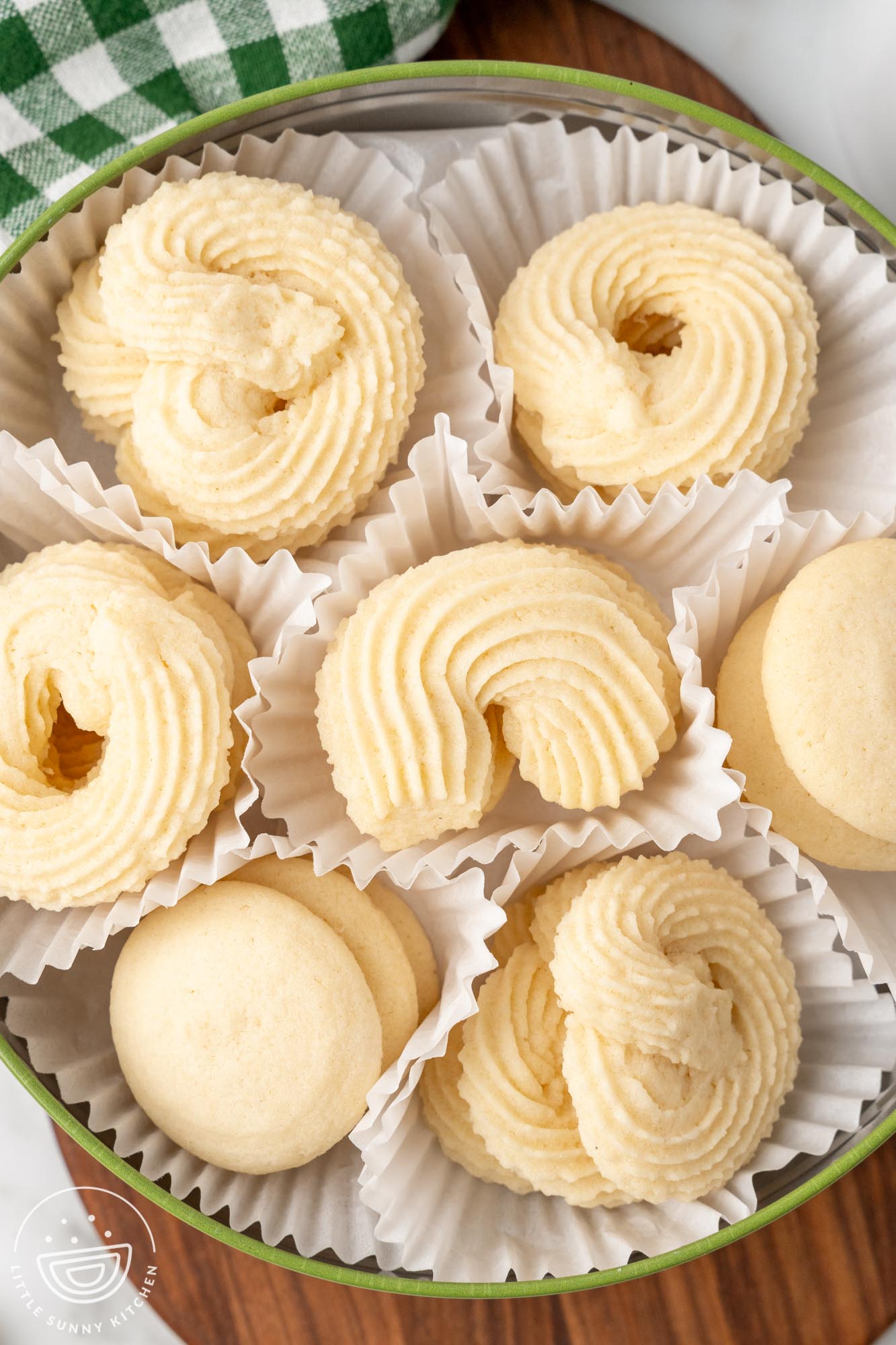 a tin of cookies wrapped in white paper liners. Homemade danish butter cookies.