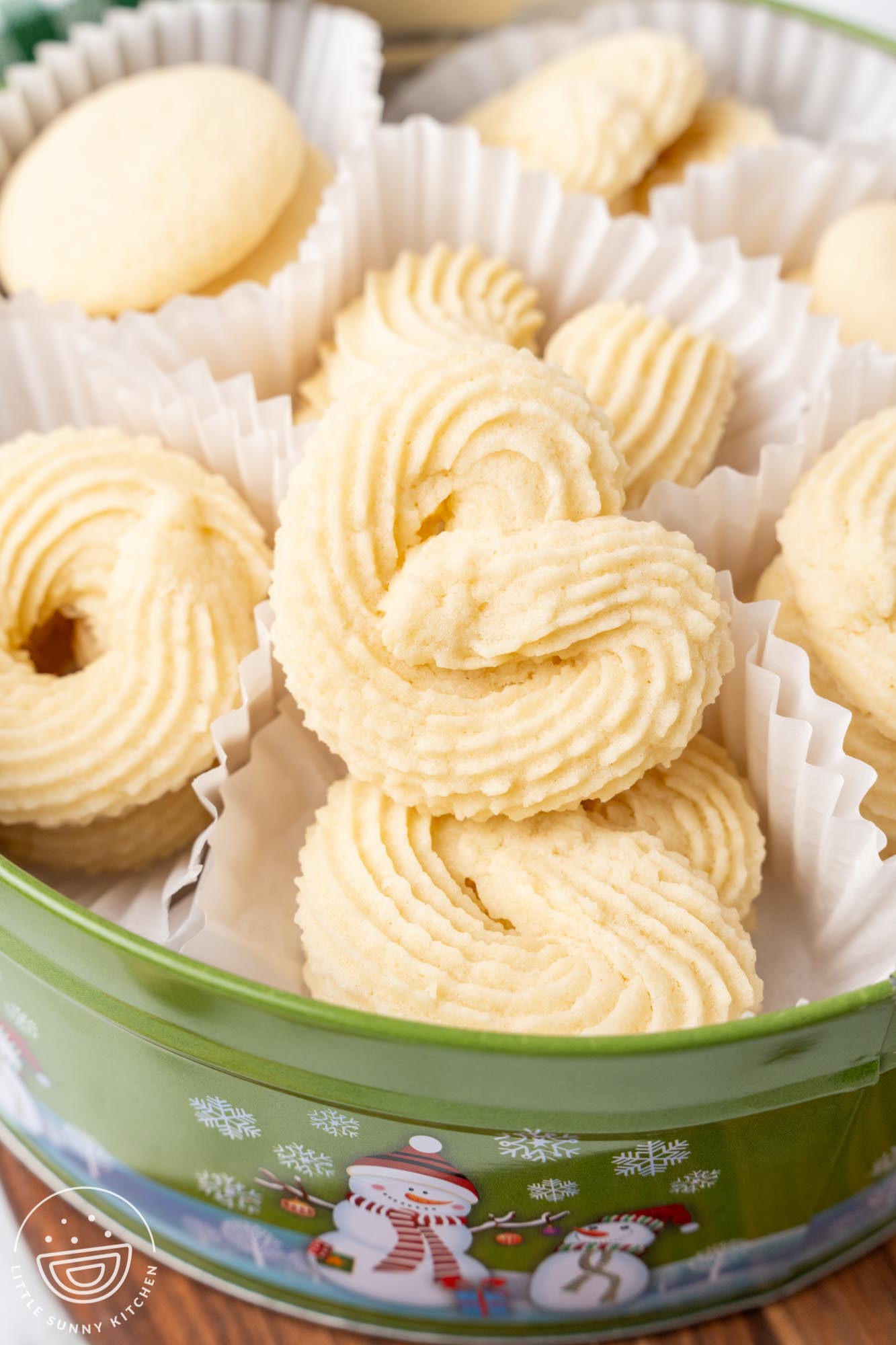 homemade danish butter cookies in a green snowman metal tin.