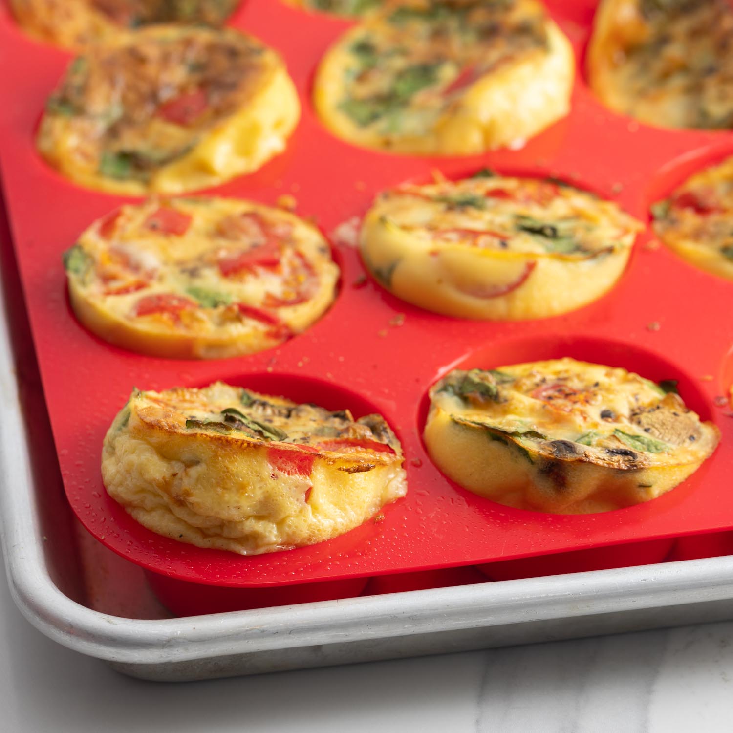 baked egg muffins easily removed from silicone muffin pan.