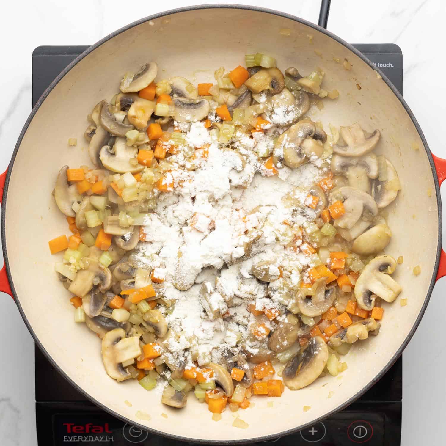 flour sprinkled over sauteed onions, carrots, mushrooms, and celery.