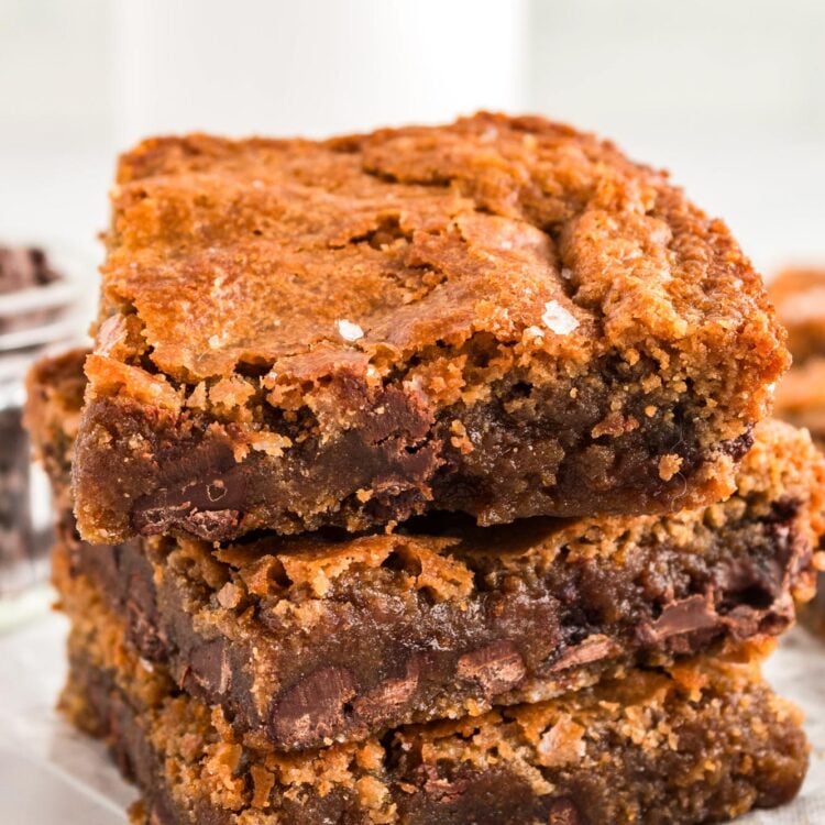 a stack of three chocolate chip brown butter blondies sprinkled with sea salt.