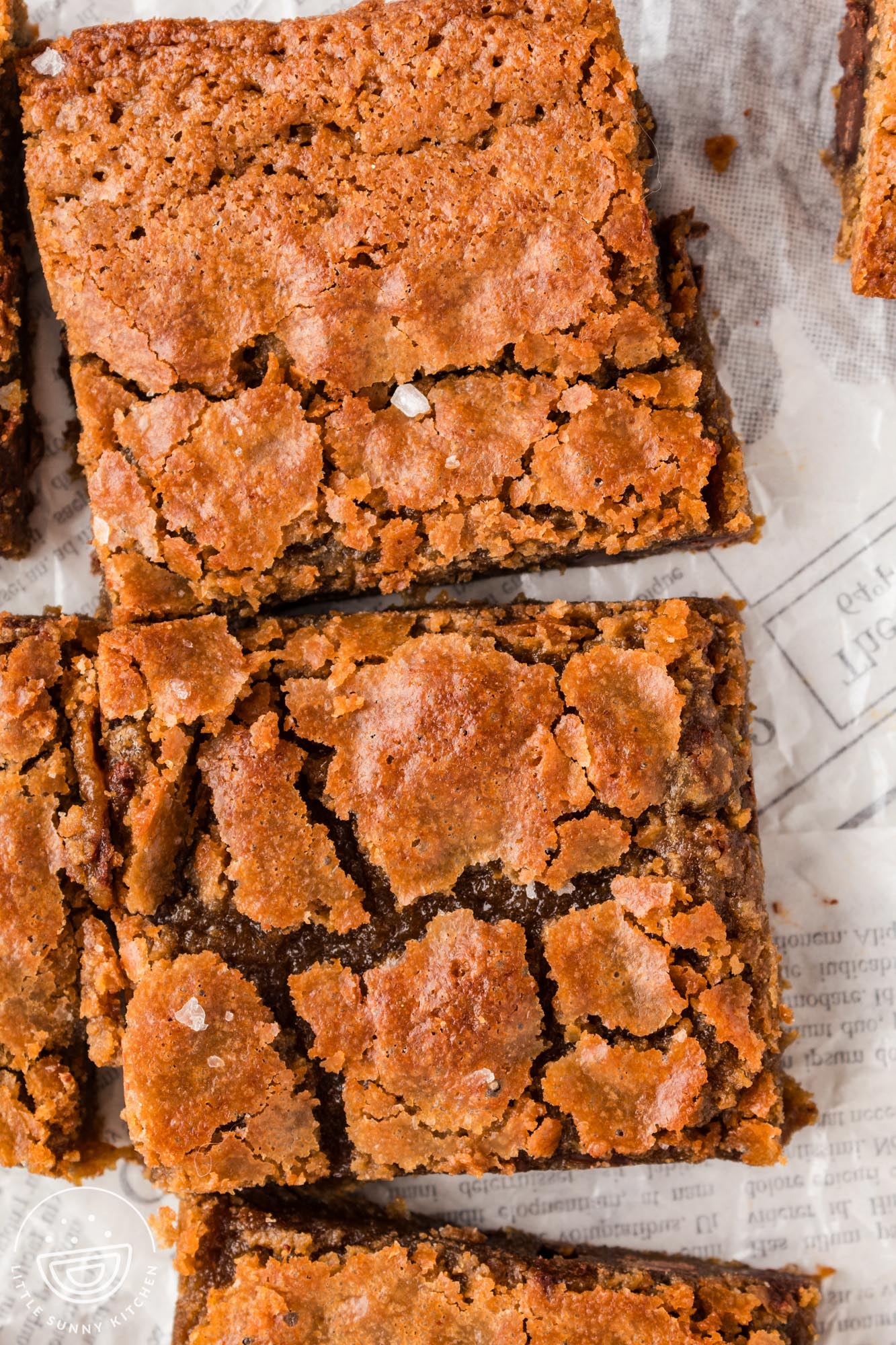 closeup of two brown butter blondies with crackled tops.