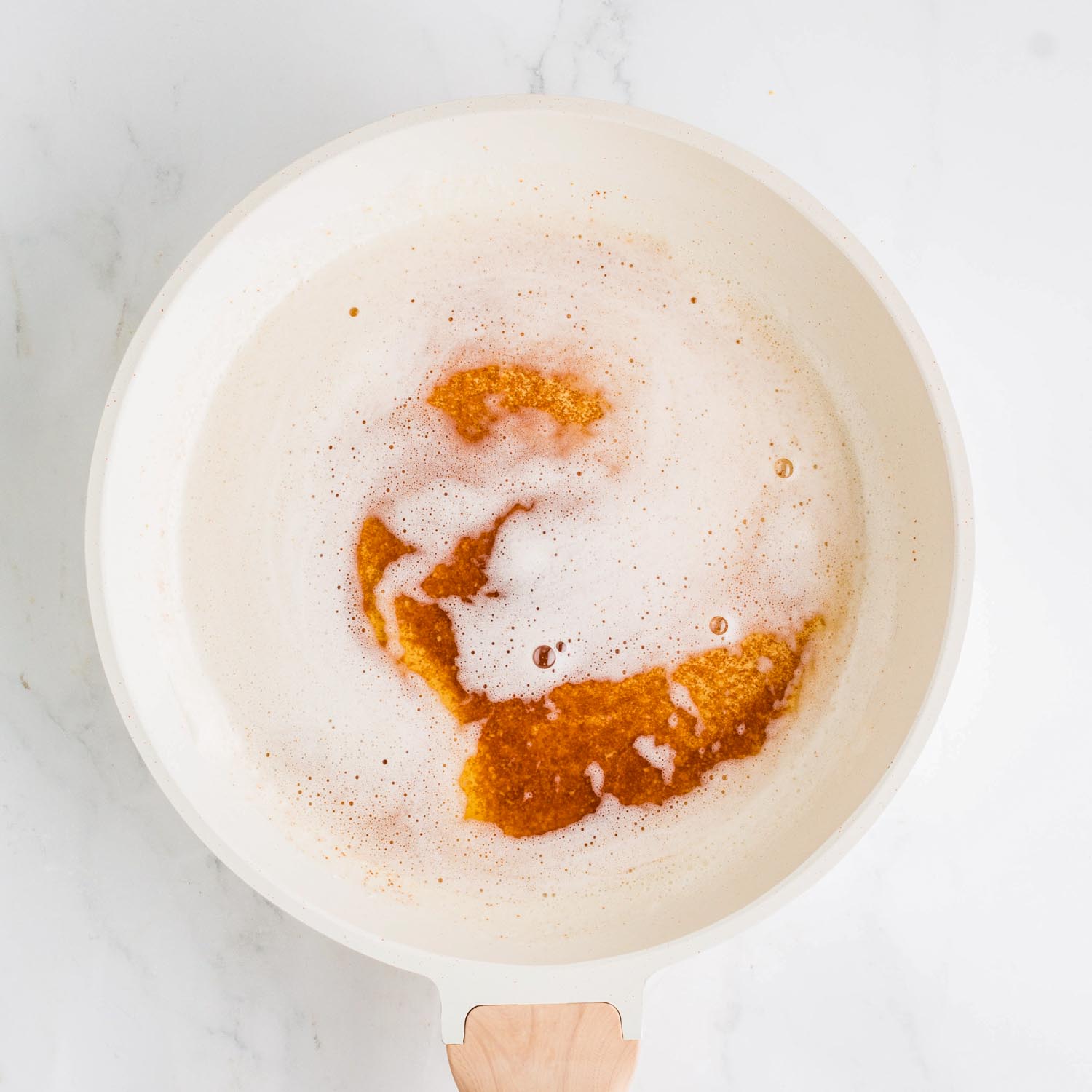 foamy browned butter in a white saucepan.