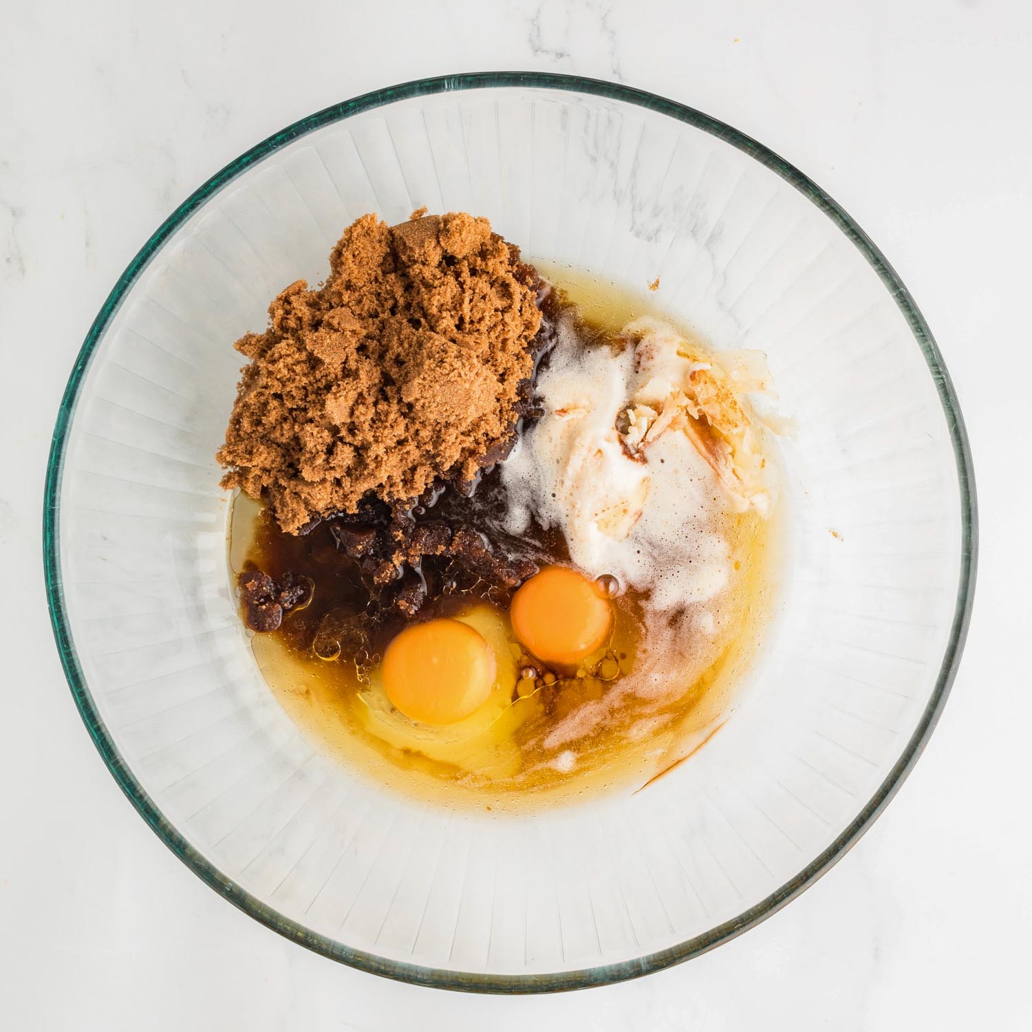 brown sugar, browned butter, eggs, and vanilla in a large glass mixing bowl.